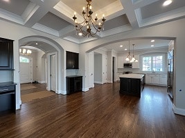 custom home's open dining to kitchen coffer arches area